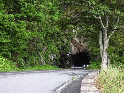 Headlights emerging from the darkness of Marys Rock Tunnel, along skyline Drive, within Shenandoah National Park, Virginia.   