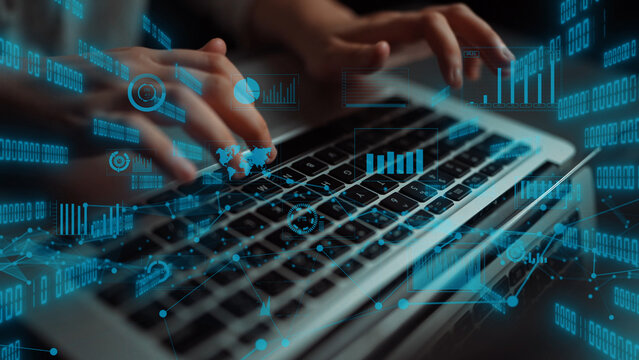 A close-up view of hands typing on a laptop, featuring overlaying digital visualizations and charts, symbolizing technology and innovation in business processes. Xenic