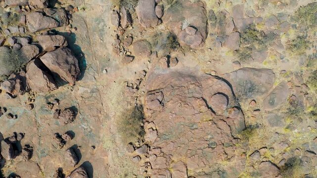 Top-Down Aerial View of Arid Rocky Terrain in Molepolole scattered boulders, dry scrub