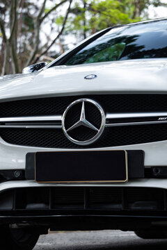 White Mercedes CLA 45 AMG front star emblem close up, Luxury sports sedan front end badge styling