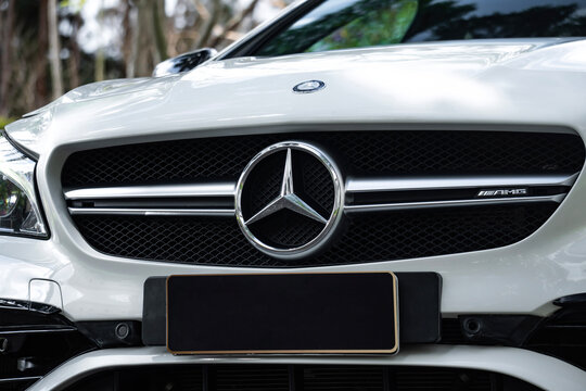White Mercedes CLA 45 AMG front star emblem close up, Luxury sports sedan front end badge styling