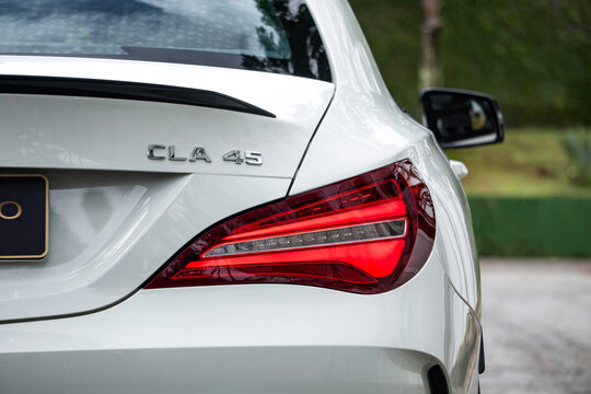 White Mercedes CLA 45 AMG taillight and model badge close up, Luxury sports car rear end logo details