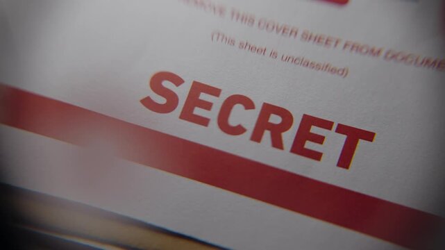 Close up on modern top secret file manila folder with label of Secret in red. Classified government information and spy agency surveillance and sensitive material inside. CIA FBI document grunge style