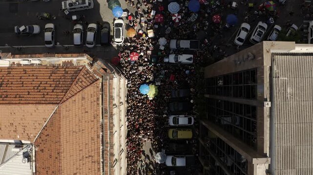 Drone Footage, Aerial View in zenital mode of big Brazilian carnival Block Parade in sunny day in Pra&ccedil;a XV Rio de Janeiro
