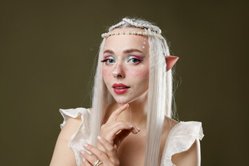 Fototapeta premium Beautiful elf girl on dark olive background