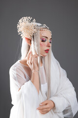 Fototapeta premium Beautiful girl dressed as elf on grey background