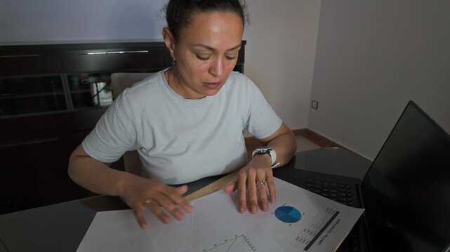 Woman Overwhelmed by Financial Documents and Bills in Home Office