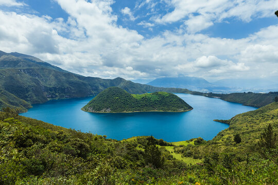 Cuicocha Crater Lake with volcanic islands in Cotacachi, Imbabura, Ecuador. Stunning Andean landscape with blue water and lush green mountains.