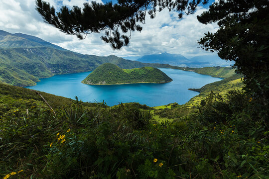 Cuicocha Crater Lake with volcanic islands in Cotacachi, Imbabura, Ecuador. Stunning Andean landscape with blue water and lush green mountains.
