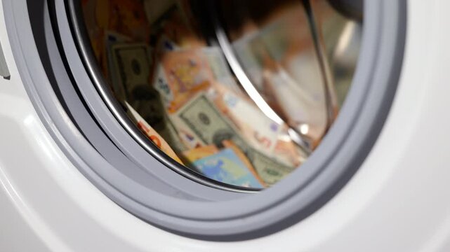 Money laundering concept. Euro and dollar banknotes spinning inside a washing machine drum, representing the financial concept of money laundering, dirty cash, illicit funds, corruption, tax evasion