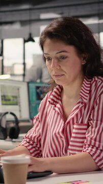Vertical Video Portrait of businesswoman inside open space office environment, creative agency staff planning strategy for development and management. Employee consultant in smart office corporation.