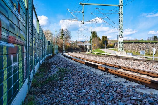 A double-track railway line with overhead wires.