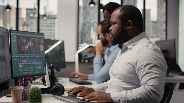 African american filmmaker working on post production process, cutting video footage for a timeline and cinematic transitions. Editing raw montage clips with color grading and visual effects.