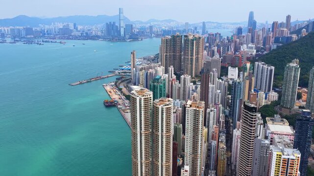 Sai Ying Pun and Kennedy Town drone shot of traditional heritage sites mixed with modern luxury skyscrapers along the Victoria Harbour waterfront in Western District Hong Kong