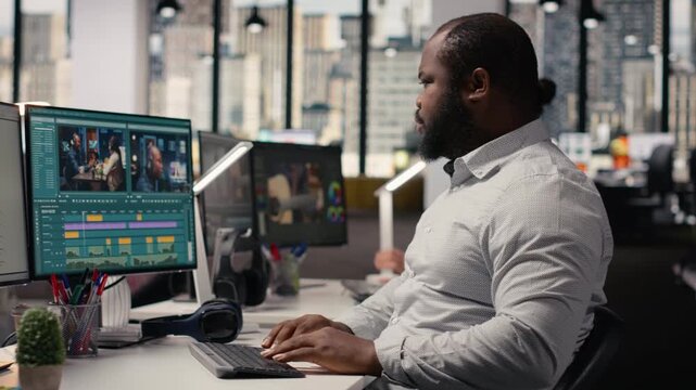 Black man working on film footage editing and cutting clips for motion graphics, creating video montage for cinematic industry and post production in creative agency office. Visual effects.
