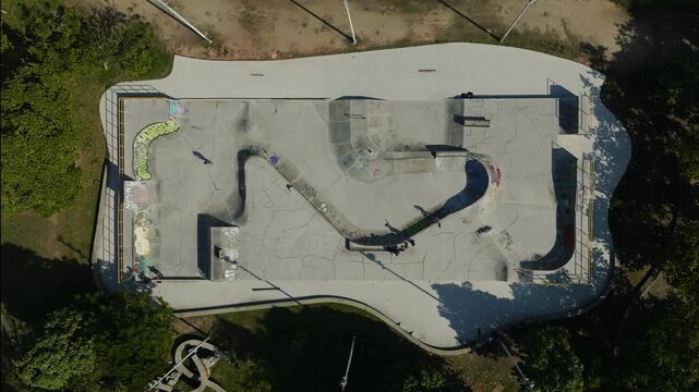 Drone footage in Zenital mode top down of the Flamengo Skatepark um Flamengo Landfill (Aterro do Flamengo) with skateboarders passing