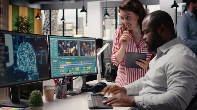 Diverse editors using AI wireframe for clips montage production, using software toolbar with sliders and controls to demonstrate machine learning, data processing and artificial intelligence tech.