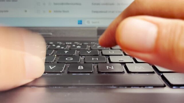 Front view of fingers typing on a laptop keyboard, focusing on black keys, symbolizing technology, digital work, communication, productivity, and the modern lifestyle of online activity