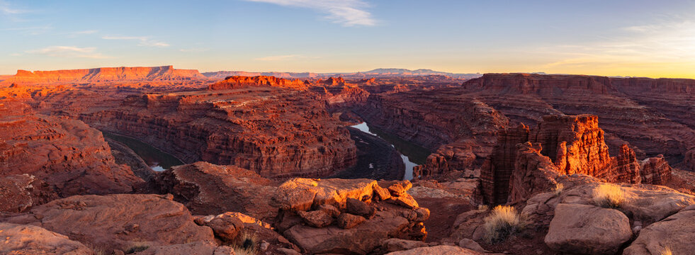 This scenic panorama was captured at sunset deep within Canyonlands National Park and features a bend in the Colorado River surrounded by rugged canyon country. 