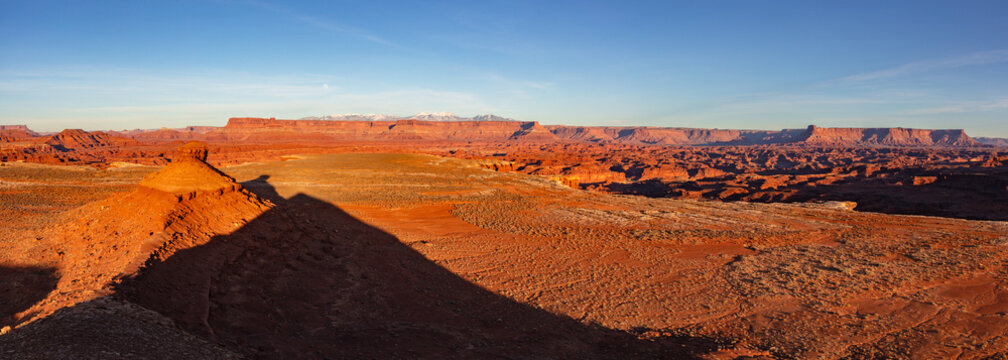 This winter sunset panorama features scenery from near the White Rim Road of Canyonlands National Park with the snow-capped La Sal Mountains in the distance.