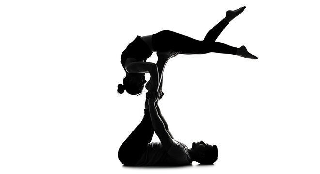 A black silhouette of a man and woman in a yoga pose on a white background