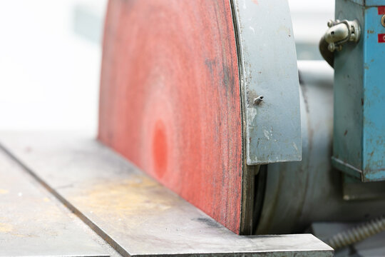 Industrial disk sander in woodworking workshop with abrasive paper