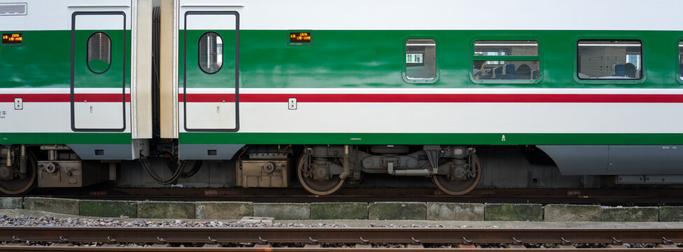 Close-up of green and white train car side