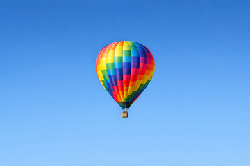 Obraz premium Colorful hot air balloon soaring against a clear blue sky