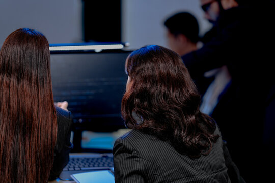 Data-driven deep dive: Analysts side-by-side, immersed in complex datasets across multiple screens. Monitoring real-time analytics or training machine learning models late night.