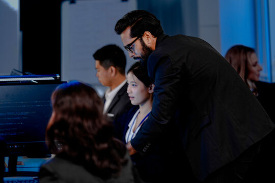 Data-driven deep dive: Analysts side-by-side, immersed in complex datasets across multiple screens. Monitoring real-time analytics or training machine learning models late night.