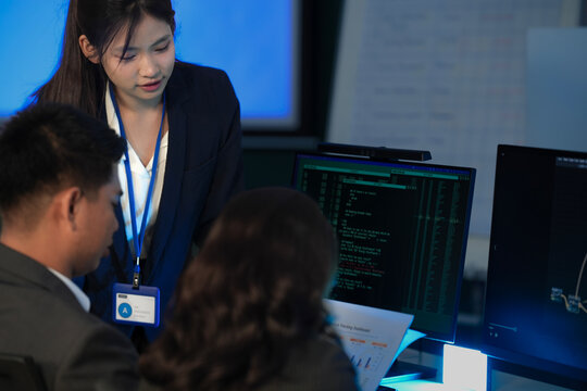 Reviewing AI generated code future workflow. Human lead points out nuances complexities AI written script screen team validates ensures alignment ethical responsible deployment cycle now.