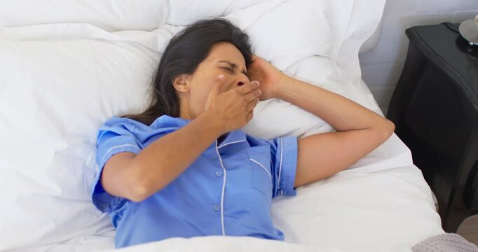 Woman lying in bed waking to light, animated sleep chart syncing yawning and stretching for health