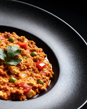 Close-up of Turkish Ali Nazik Kebab in a Black Bowl