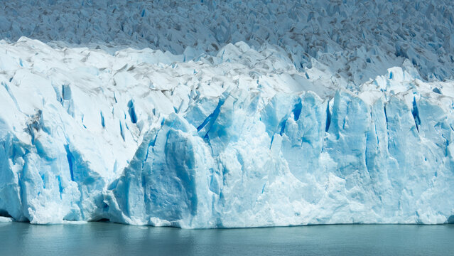 Detailed close-up of Perito Moreno Glacier showing sharp blue ice formations, crevasses and textured frozen surface in Patagonia, Argentina