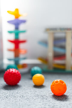 colorful toddler sensory balls and slide toys in child bedroom for early learning