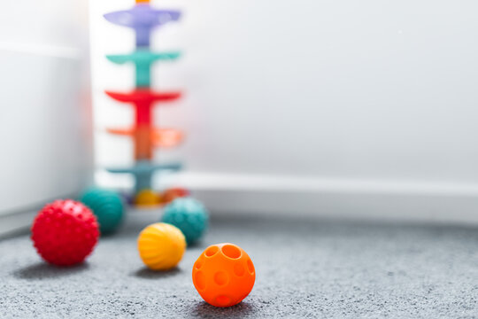 colorful toddler sensory balls and slide toys in child bedroom for early learning