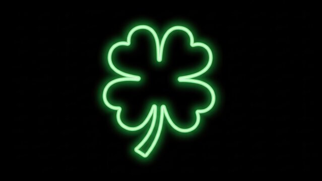 Glowing vibrant green four-leaf clover neon light sign illuminating a dark background