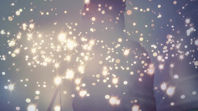 Vertical video: Male singer singing into mic, particles rising then thinning, revealing music act