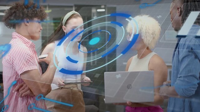 Team standing in lounge tapping tablet sharing laptop while holo UI rising guiding business review