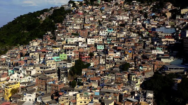 Drone Footage, Aerial View traveling out from Favela Houses of Morro do Vidigal near the sea in Rio de Janeiro