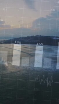 Vertical video: Data overlay appearing over coastal dusk, light fading, updating bars showing data