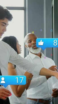 Vertical video: Marketing team pointing and placing notes on glass wall, reacting to social bubbles