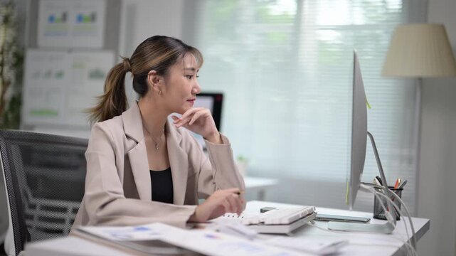 Young Woman Working at Desk with Computer and Office Supplies