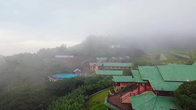 Misty Mountain Landscape in Doi Mae Salong Thailand with Fog and Hillside Resort