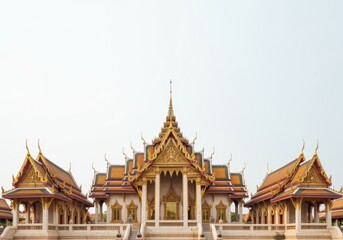Fototapeta premium Traditional Ornate Asian Temple Building with Tiered Roof and Golden Details Isolated on White Sunlight Backdrop for Travel Guide or Architecture Study Publication