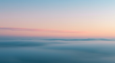 Fototapeta premium Abstract misty sunrise background with blue and amber gradient of soft clouds as a serene landscape for wellness app header or meditation backdrop with copy space