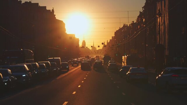 Saint-Petersburg, Russia - April 10 2026, 4k, panoramic view of Nevsky Prospect, cars on road, people walking on sidewalk, at sunset with bright sun, everything in orange light, St Petersburg, Russia