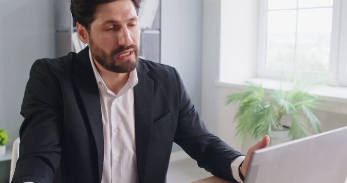 Office online video conference, man presenting document to boss or client, holding charts and graphs paper, explaining data, focused and engaged, communicating showing findings and analysis,