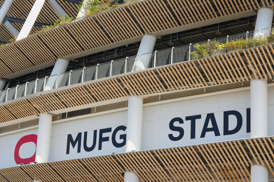 TOKYO, JAPAN - April 3, 2026: Detail of the MUFG Stadium, the National Stadium, including a large sign.