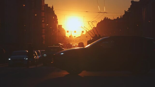 Saint-Petersburg, Russia - April 10 2026, 4k, panoramic view of Nevsky Prospect, cars on road, people walking on sidewalk, at sunset with bright sun, everything in orange light, St Petersburg, Russia
